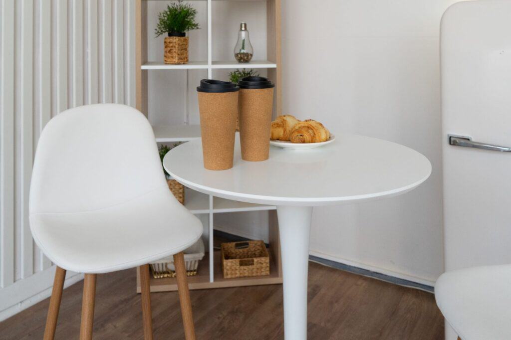 A small white coffee table with chairs