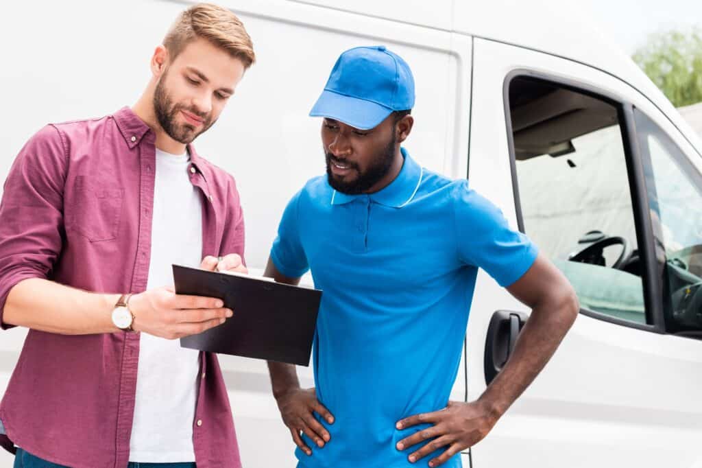 A client with the Man and Van rider reviewing a checklist.