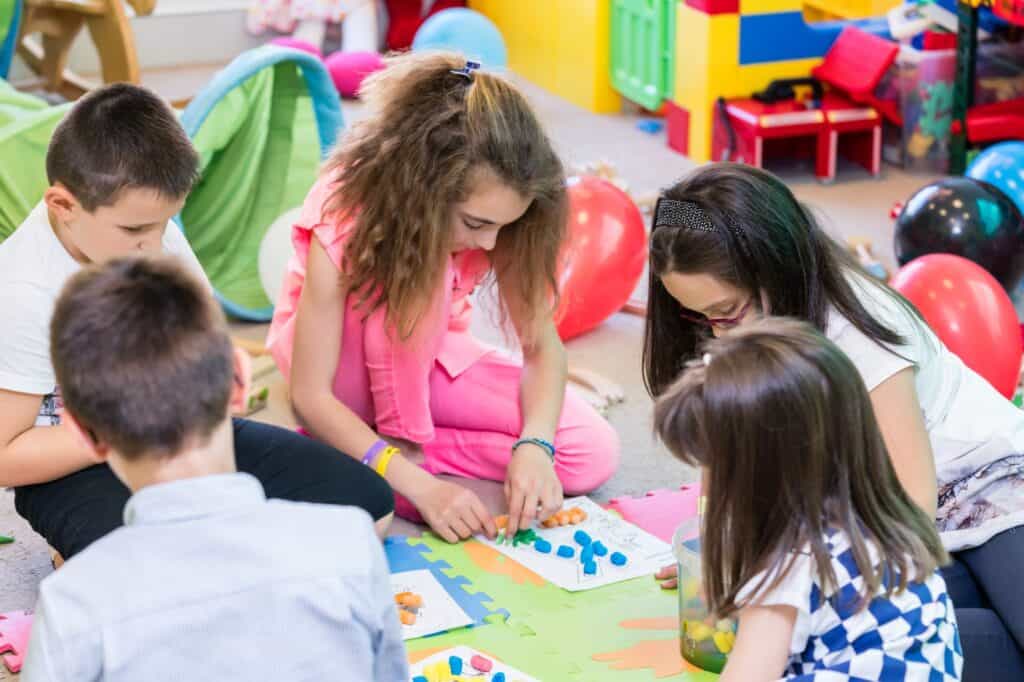 Young students working with plasticine in an arts class in the concept of 'top schools in Ealing'.